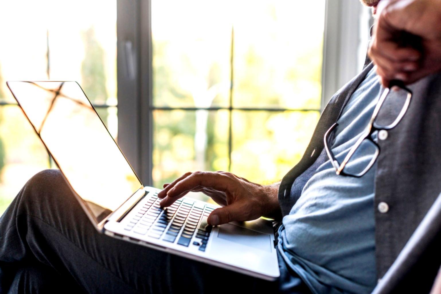 Student using financial planning materials and digital tools on laptop